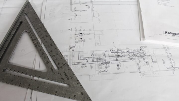 Architectural blueprint and plan on a desk, representing a structured go-to-market plan for a bootstrapped startup