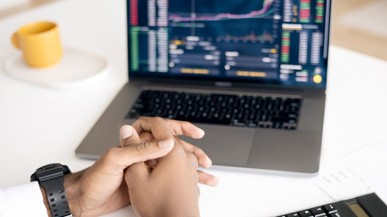 Person comparing pricing plans and options on a laptop screen, representing bottom-of-funnel buyer research