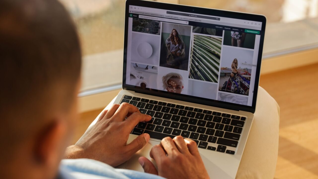 Founder reviewing their brand's search results and competitor ads on a laptop