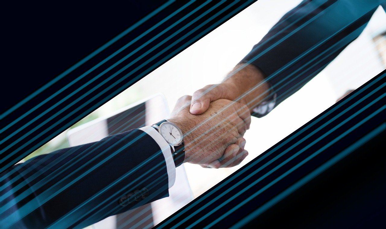 Two business partners shaking hands, representing trust built between a brand and an online customer in India