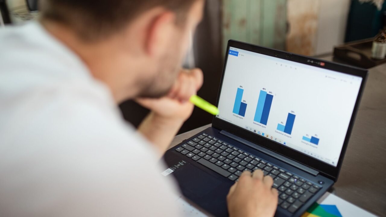 Marketer comparing commercial and informational keyword data on a laptop screen