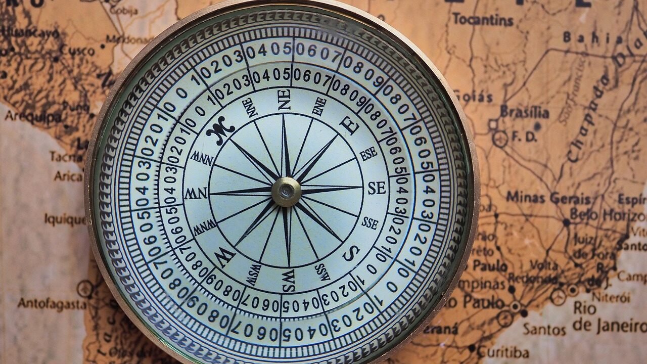 A vintage compass and map, representing a business finding direction and strategy to compete against dominant online directories in Indian search results.