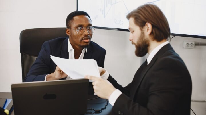 Marketer comparing competitor data on a laptop screen while researching brand keyword strategy