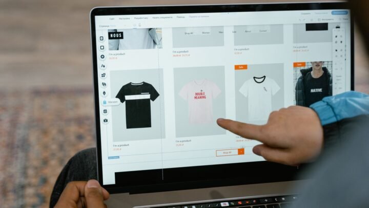 Ecommerce manager reviewing a product category page and keyword list on a laptop