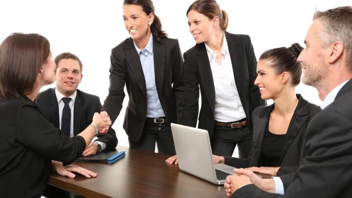Business meeting and handshake representing the interview process for hiring a first in-house SEO specialist