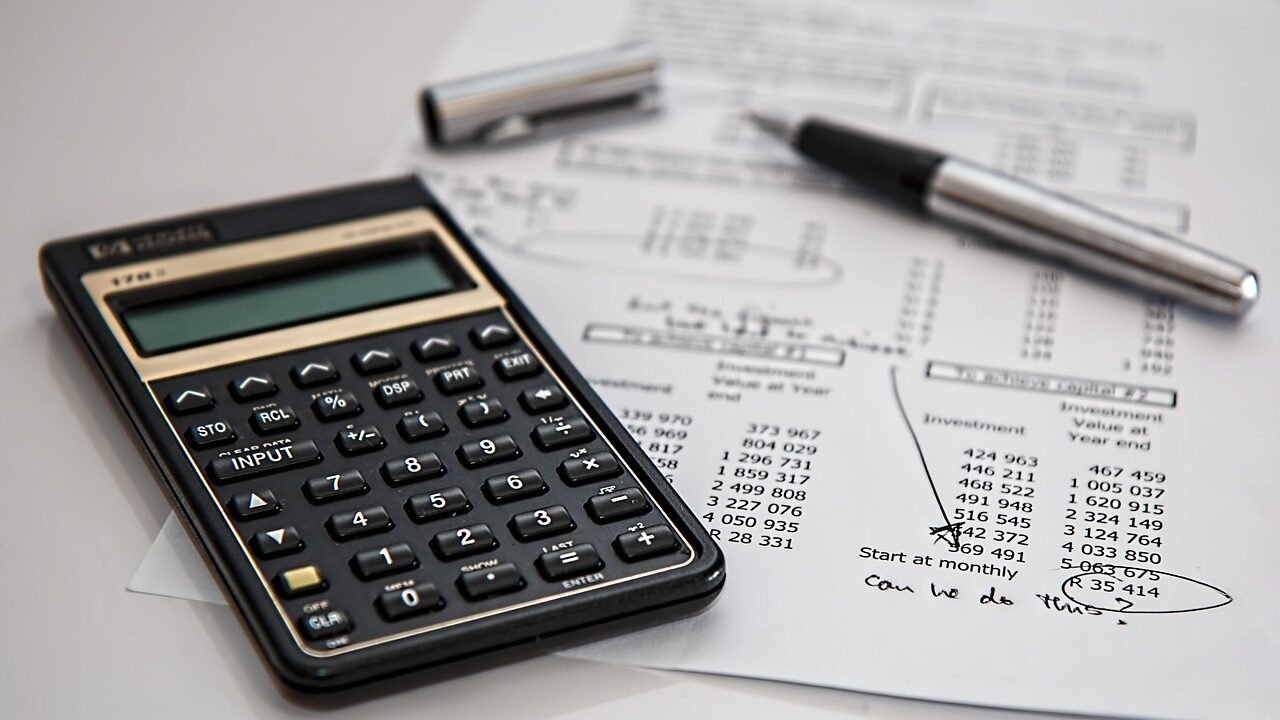 Calculator and financial documents representing the cost comparison between in-house SEO, agency retainers, and freelancers