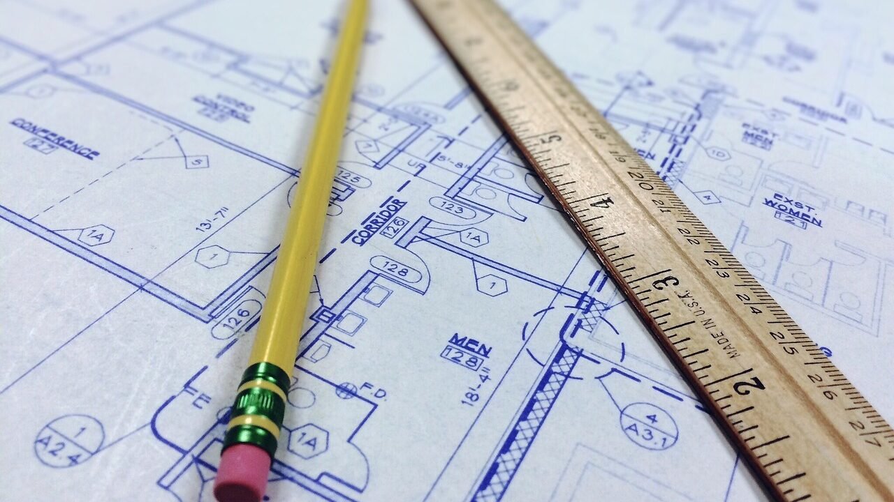 Architectural blueprint and ruler representing the technical setup plan for international targeting on a .in domain