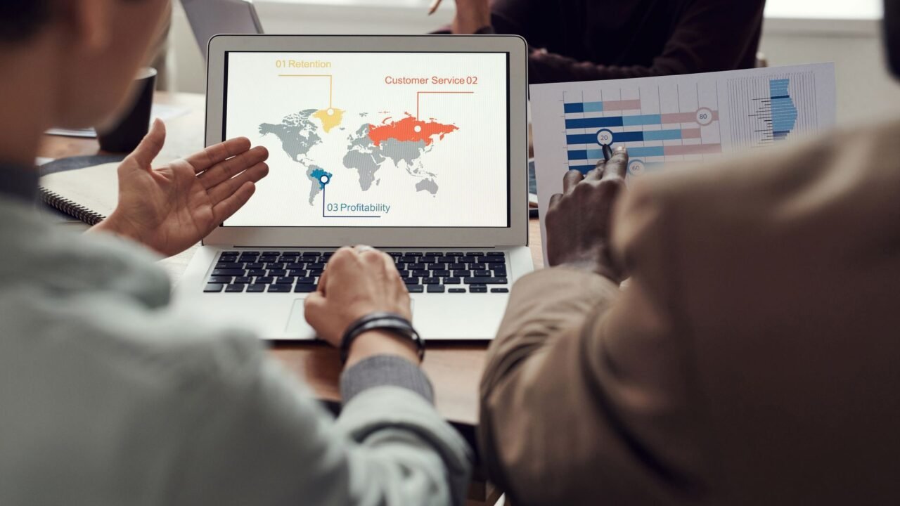 Marketer comparing keyword ranking data between two competitor websites on a laptop