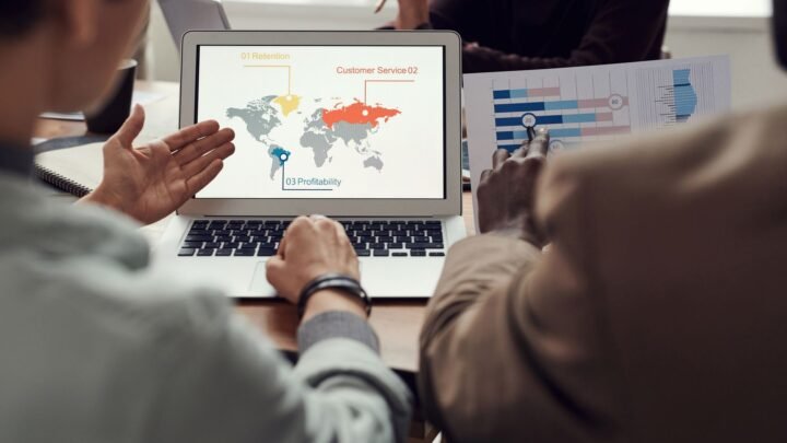 Marketer comparing keyword ranking data between two competitor websites on a laptop