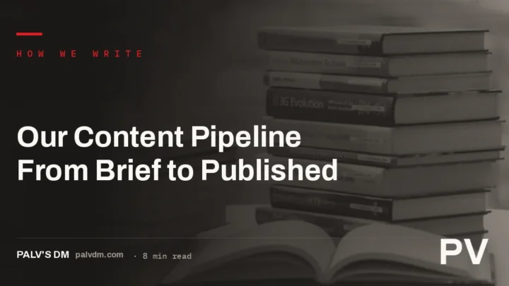 Editor reviewing an article draft on a laptop next to stacked reference books, representing the content production process