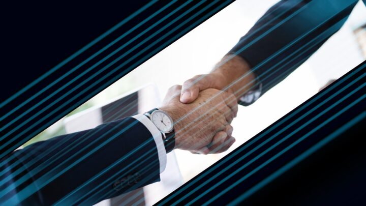 Two business partners shaking hands, representing a referral partnership agreement