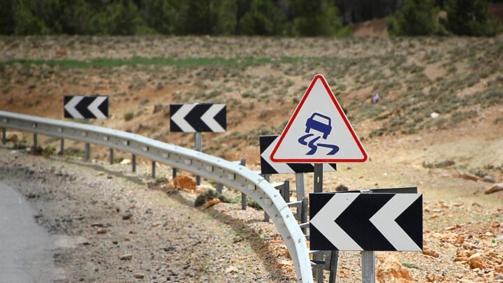 A yellow warning sign on a roadside, symbolizing red flags to watch for in an SEO proposal