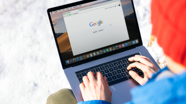 Marketer reviewing Google Search Console query rankings on a laptop to find striking-distance keywords