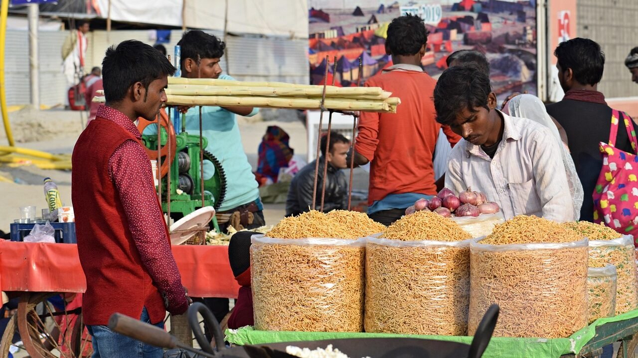 Street vendor in an Indian market selling directly to a customer, representing direct chat-based buying behaviour